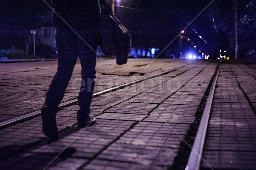 Чувак идёт по трамвайным путям