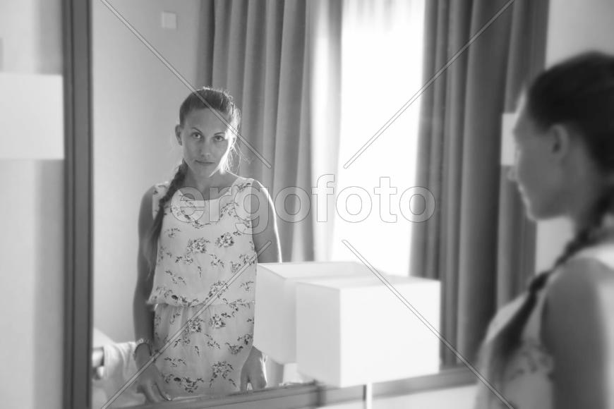Девушка смотрит в зеркало