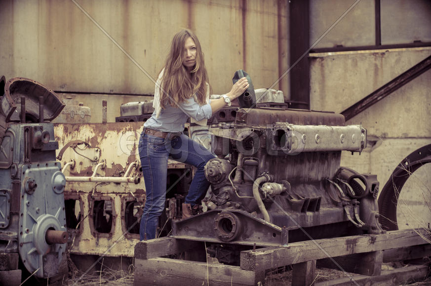 Девушка с канистрой у двигателя