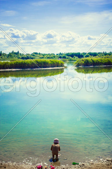 Ребенок на берегу водоема 