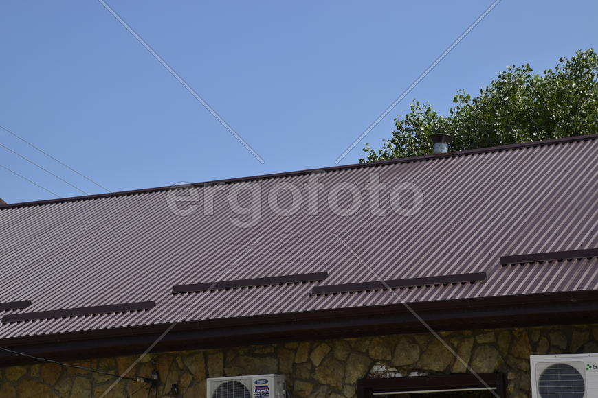 The roof of corrugated sheet. Roofing of metal profile wavy shape.