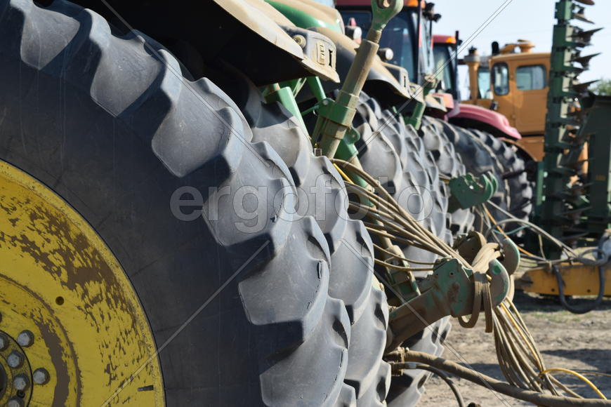 Tractor, standing in a row. Agricultural machinery. Parking of agricultural machinery.