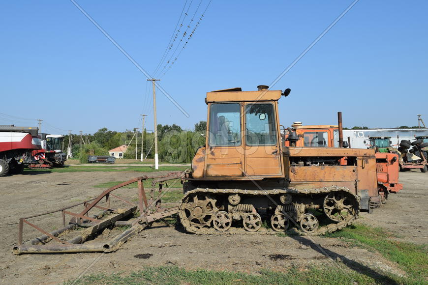 Tractor, standing in a row. Agricultural machinery. Parking of agricultural machinery.