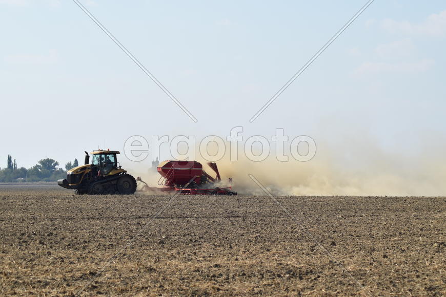 Russia, Temryuk - 19 July 2015: Tractor rides on the field and makes the fertilizer into the soil. C