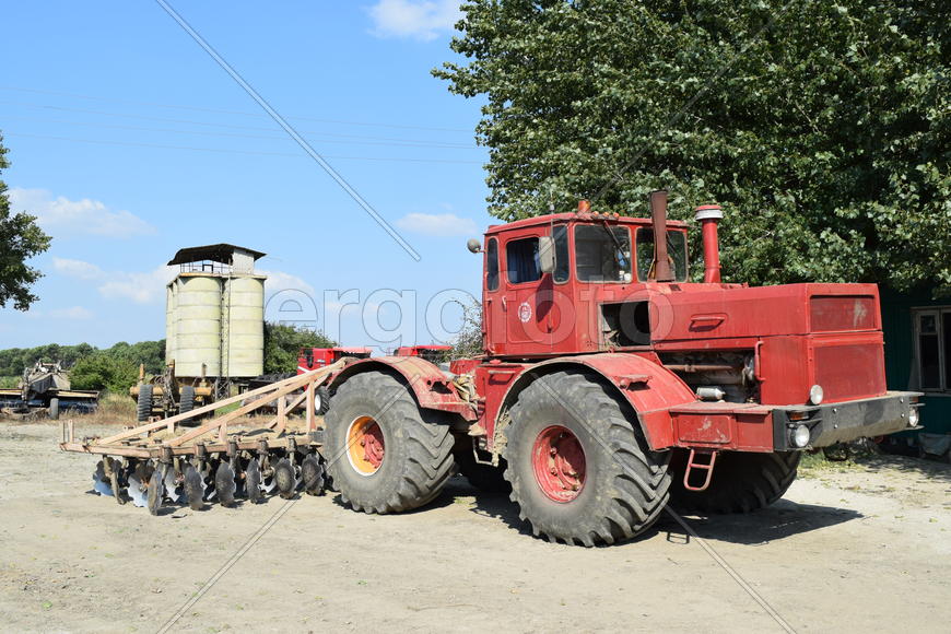 Tractor, standing in a row. Agricultural machinery. Parking of agricultural machinery.