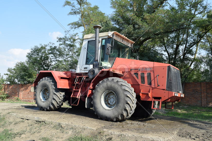 Tractor, standing in a row. Agricultural machinery. Parking of agricultural machinery.