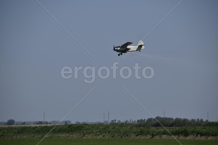Aircraft agricultural aviation AN-2. The spraying of fertilizers and pesticides on the field with th