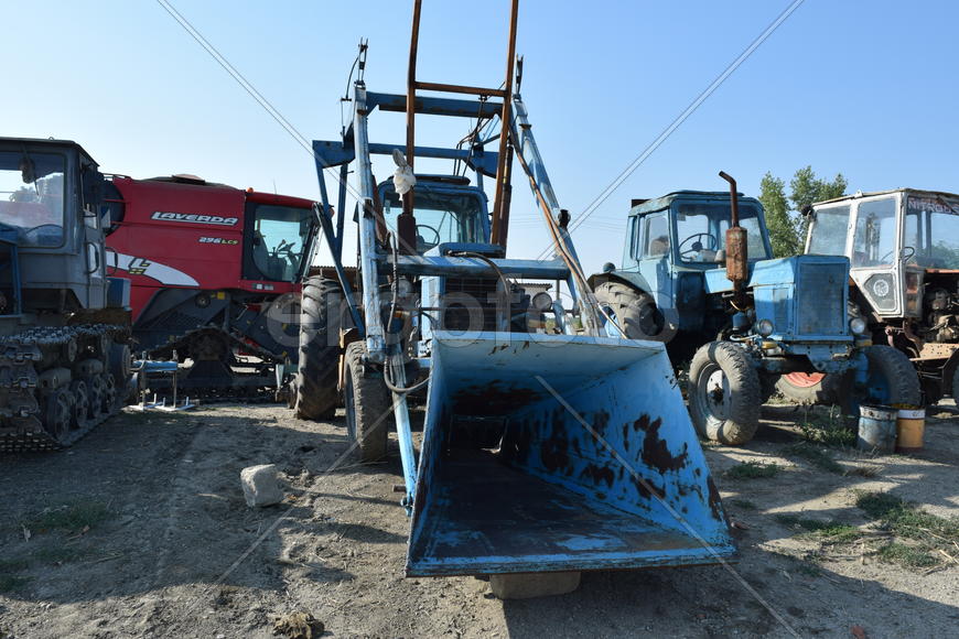 Tractor, standing in a row. Agricultural machinery. Parking of agricultural machinery.