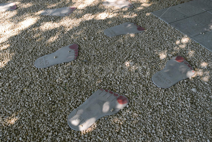 Tile in the form of foot of the person. A footpath in park