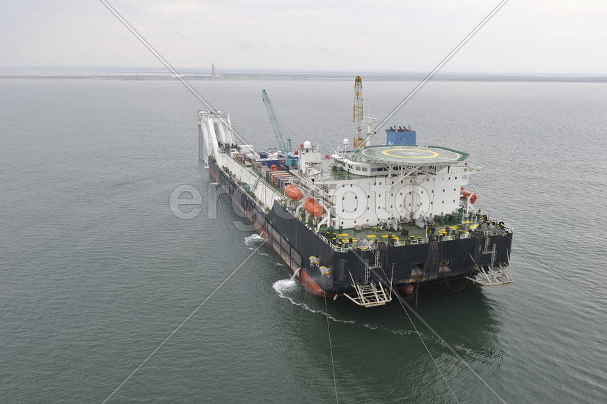 The cargo ship with the crane, the top view. Pipelaying barge
