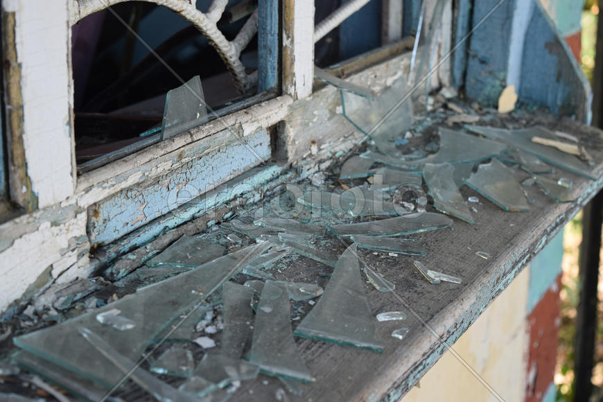 Windows with the broken glasses. The old thrown gas station