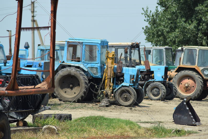 Russia, Temryuk - 15 July 2015: Tractor, standing in a row. Agricultural machinery. Parking of agric
