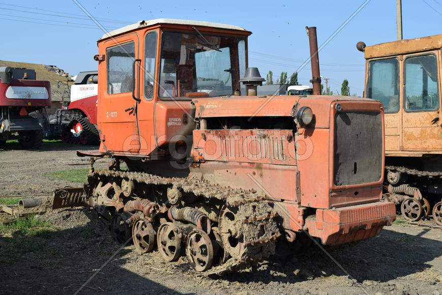 Tractor, standing in a row. Agricultural machinery. Parking of agricultural machinery.