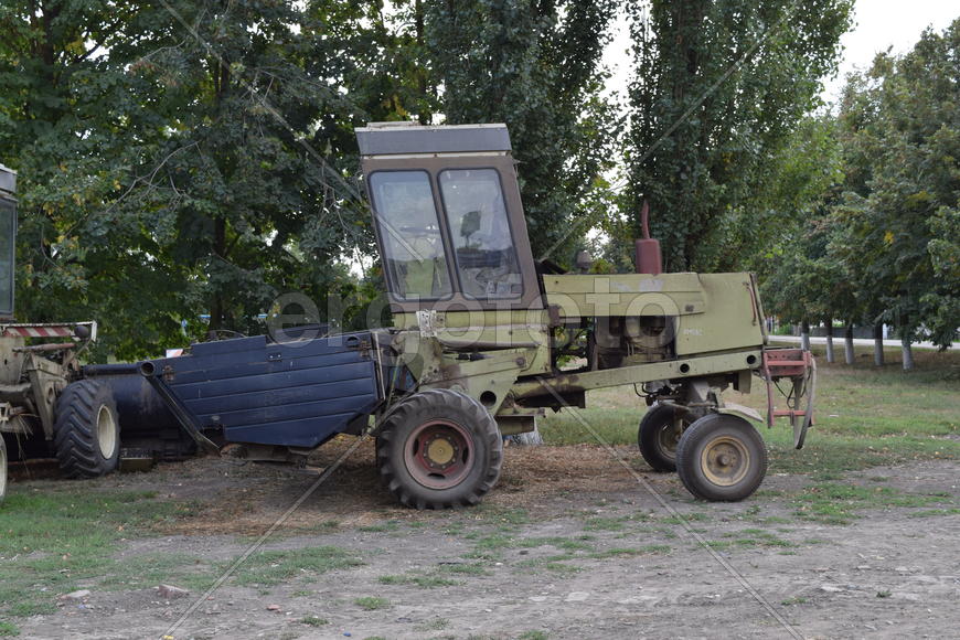 Tractor, standing in a row. Agricultural machinery. Parking of agricultural machinery.