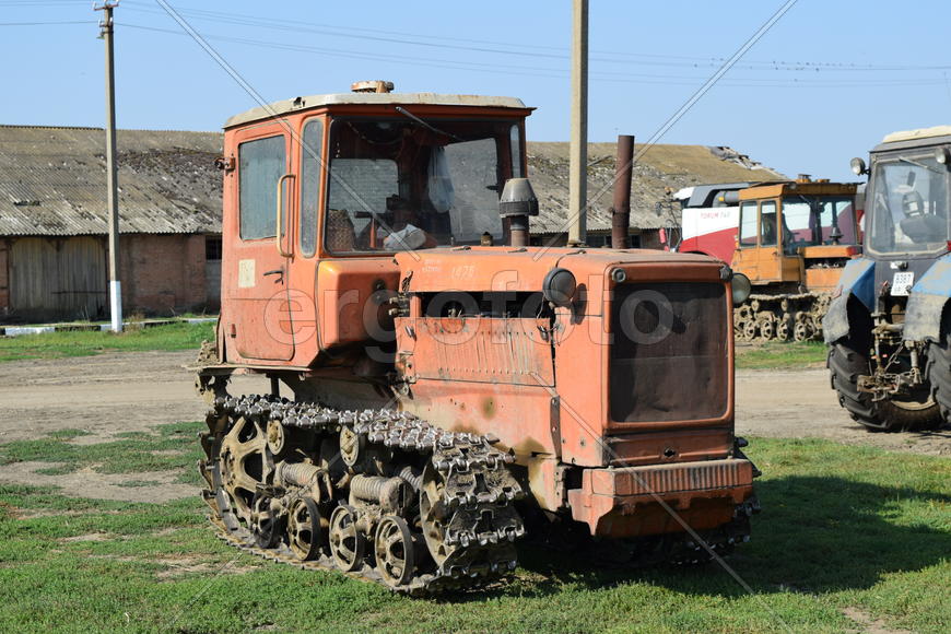 Tractor, standing in a row. Agricultural machinery. Parking of agricultural machinery.