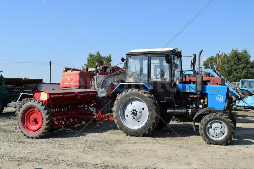 Tractor, standing in a row. Agricultural machinery. Parking of agricultural machinery.