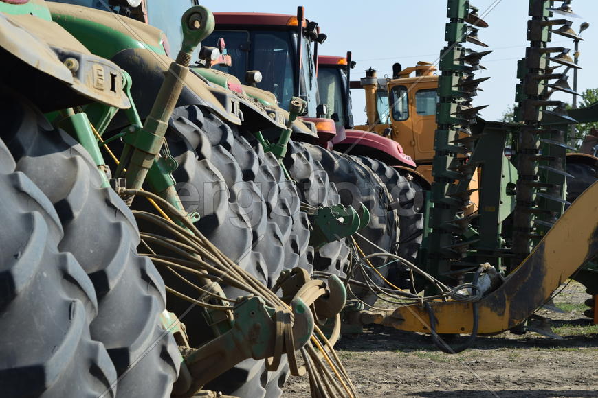 Tractor, standing in a row. Agricultural machinery. Parking of agricultural machinery.