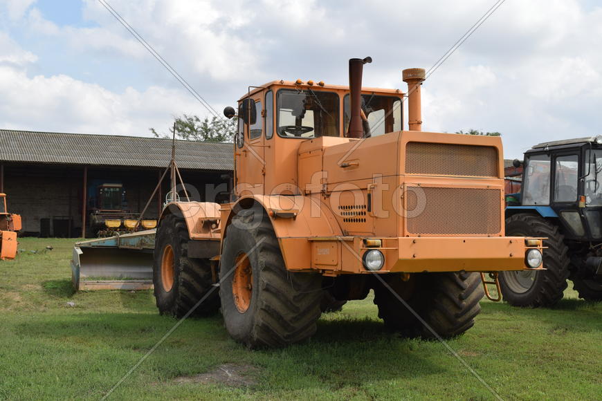 Tractor, standing in a row. Agricultural machinery. Parking of agricultural machinery.