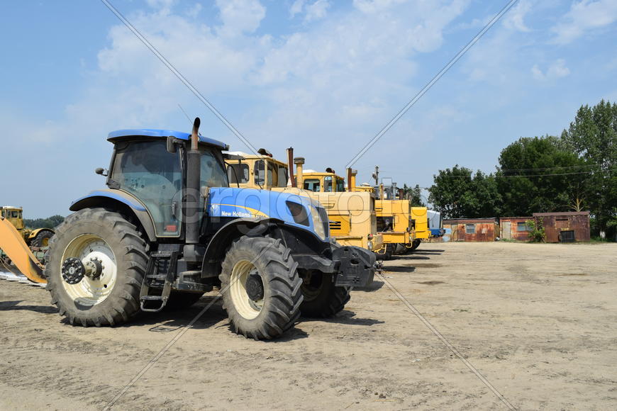 Russia, Temryuk - 15 July 2015: Tractor, standing in a row. Agricultural machinery. Parking of agric