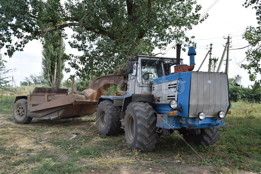 Tractor, standing in a row. Agricultural machinery. Parking of agricultural machinery.