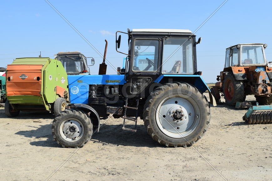Tractor, standing in a row. Agricultural machinery. Parking of agricultural machinery.