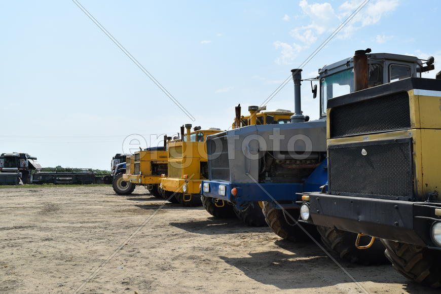 Russia, Temryuk - 15 July 2015: Tractor, standing in a row. Agricultural machinery. Parking of agric