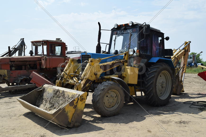 Russia, Temryuk - 15 July 2015: Tractor, standing in a row. Agricultural machinery. Parking of agric