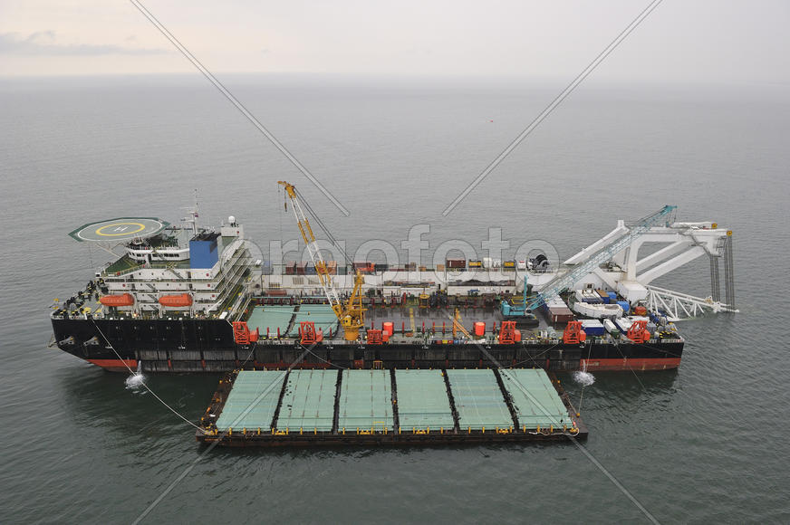 The cargo ship with the crane, the top view. Pipelaying barge