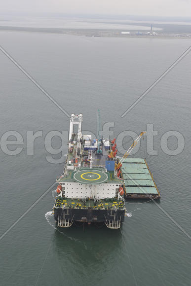 The cargo ship with the crane, the top view. Pipelaying barge