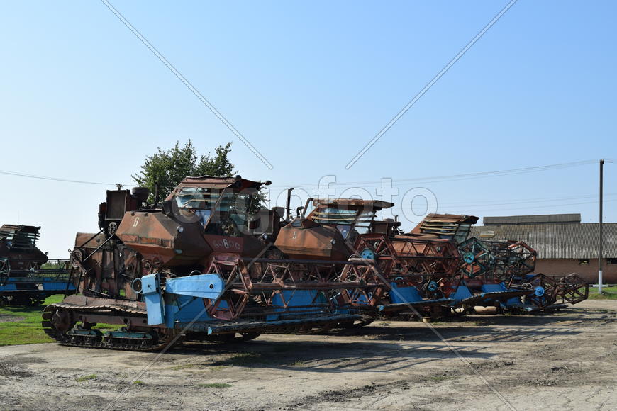 Tractor, standing in a row. Agricultural machinery. Parking of agricultural machinery.