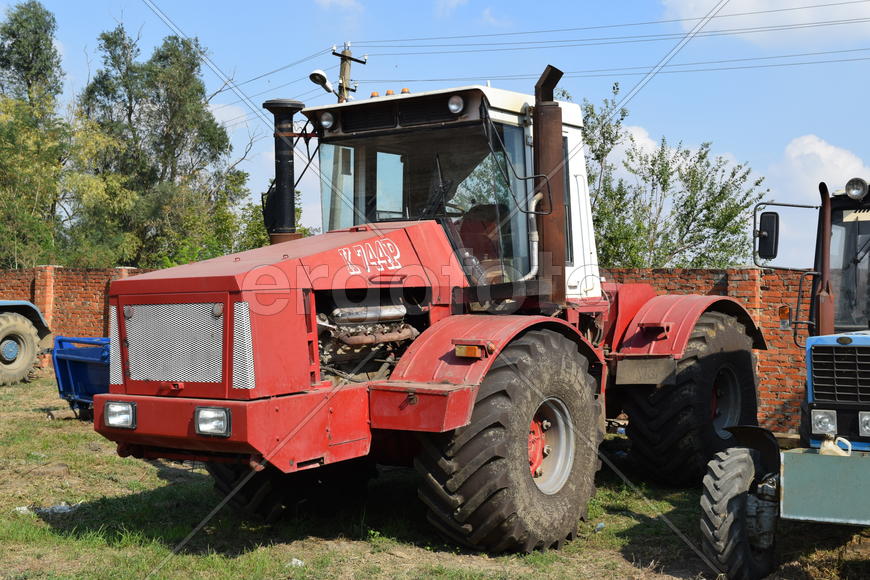 Tractor, standing in a row. Agricultural machinery. Parking of agricultural machinery.