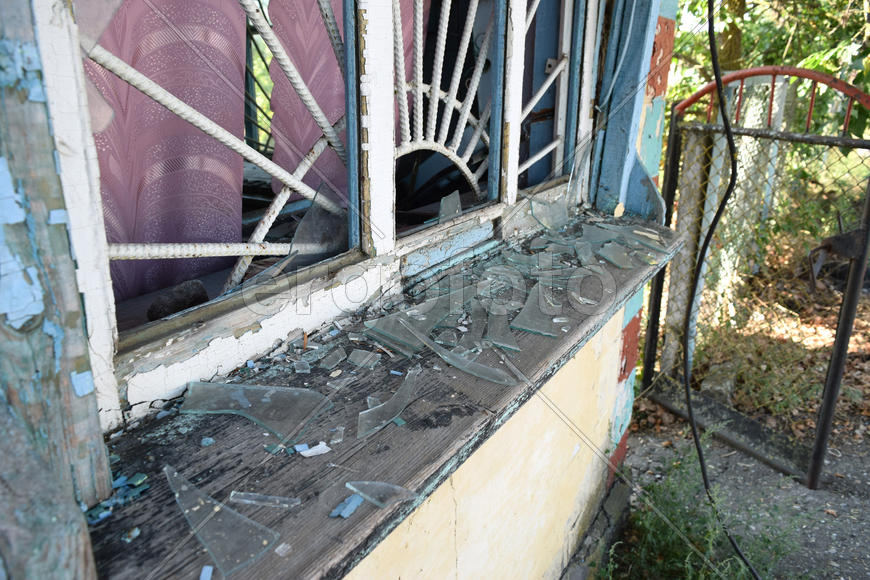 Windows with the broken glasses. The old thrown gas station