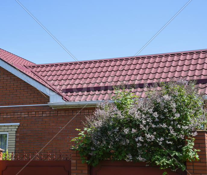 The roof of corrugated sheet. Roofing of metal profile wavy shape.