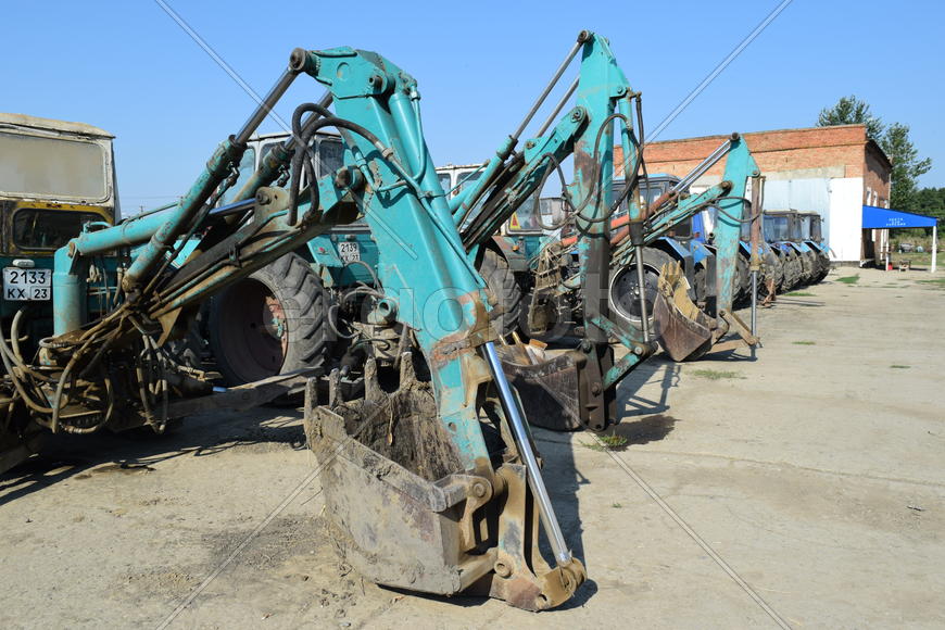 Tractor, standing in a row. Agricultural machinery. Parking of agricultural machinery.