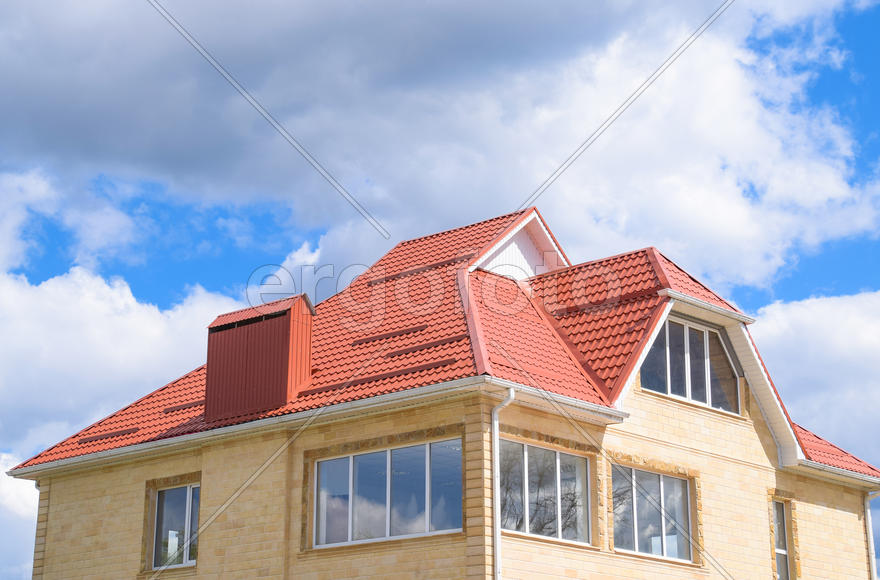 The house with plastic windows and a roof of corrugated sheet. 
