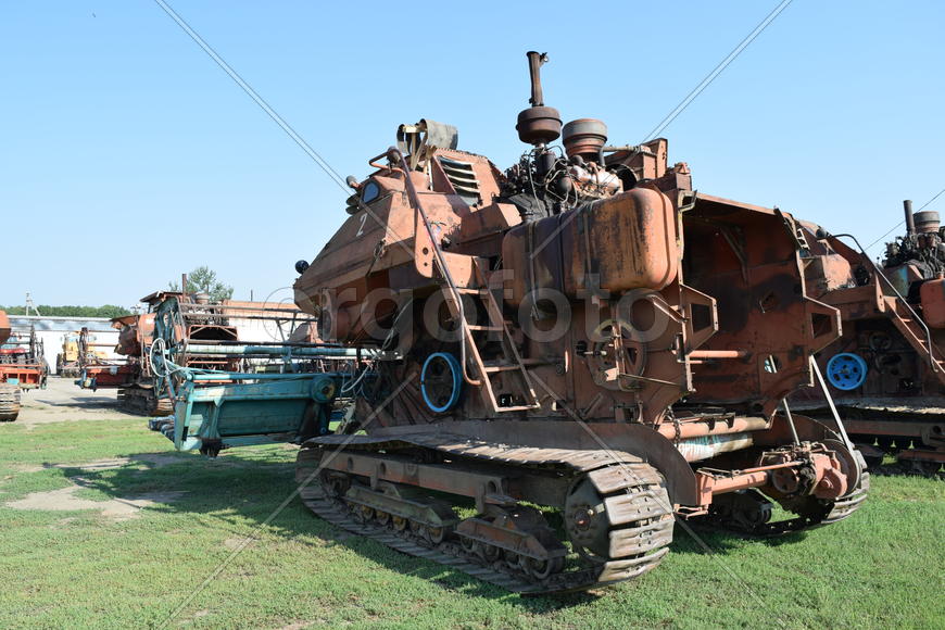 Tractor, standing in a row. Agricultural machinery. Parking of agricultural machinery.