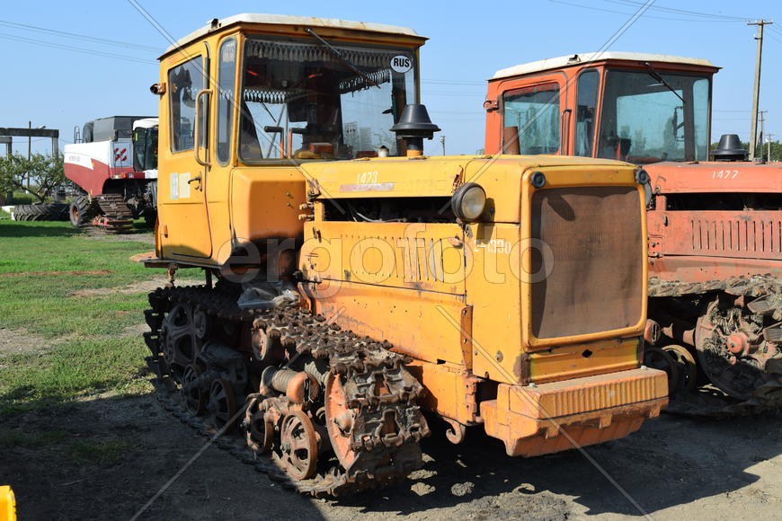Tractor, standing in a row. Agricultural machinery. Parking of agricultural machinery.