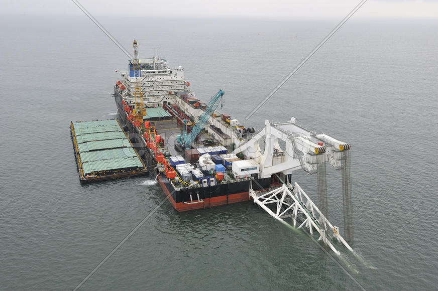 The cargo ship with the crane, the top view. Pipelaying barge