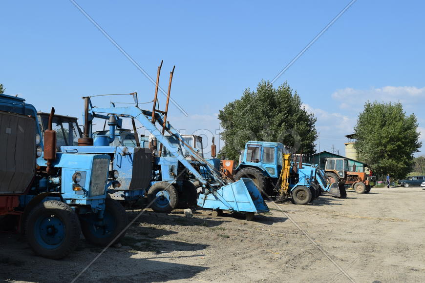 Tractor, standing in a row. Agricultural machinery. Parking of agricultural machinery.