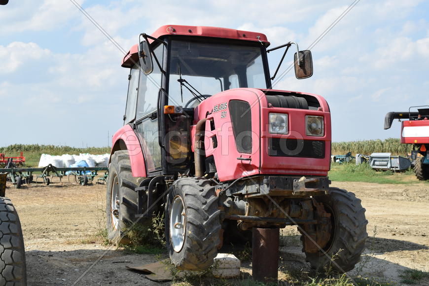 Tractor, standing in a row. Agricultural machinery. Parking of agricultural machinery.