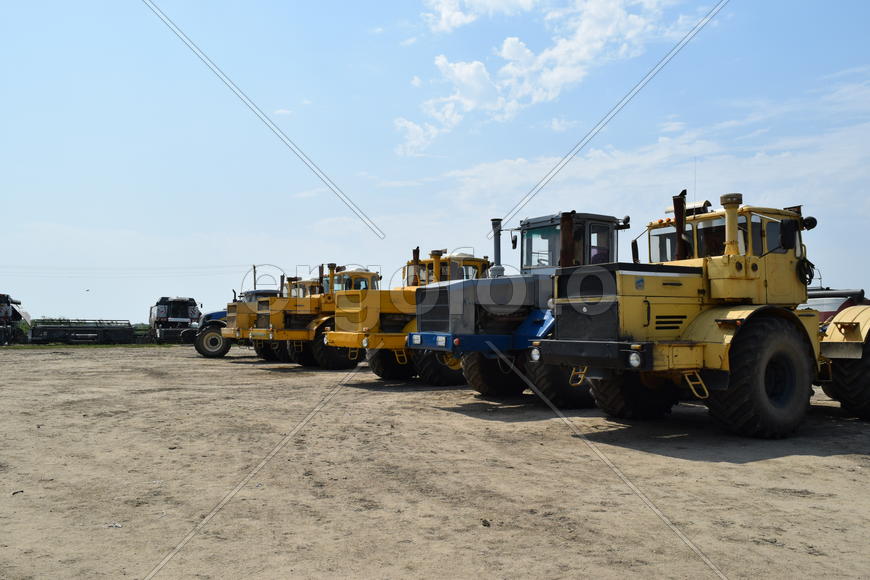 Russia, Temryuk - 15 July 2015: Tractor, standing in a row. Agricultural machinery. Parking of agric