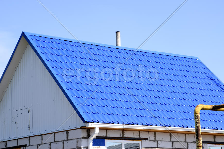 The roof of corrugated sheet. Roofing of metal profile wavy shape.