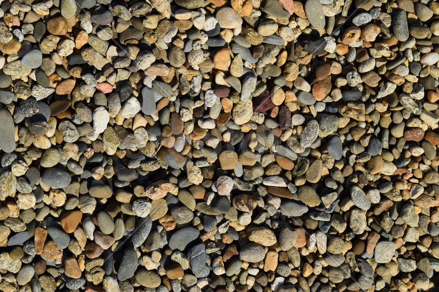 Background from small round crushed stone. A heap from a small pellet