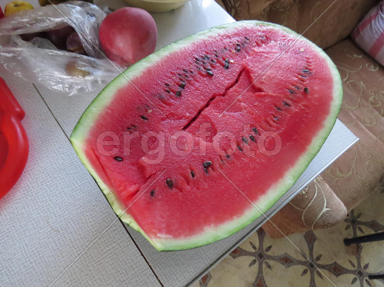 Cut watermelon in half long. The harvest from the garden