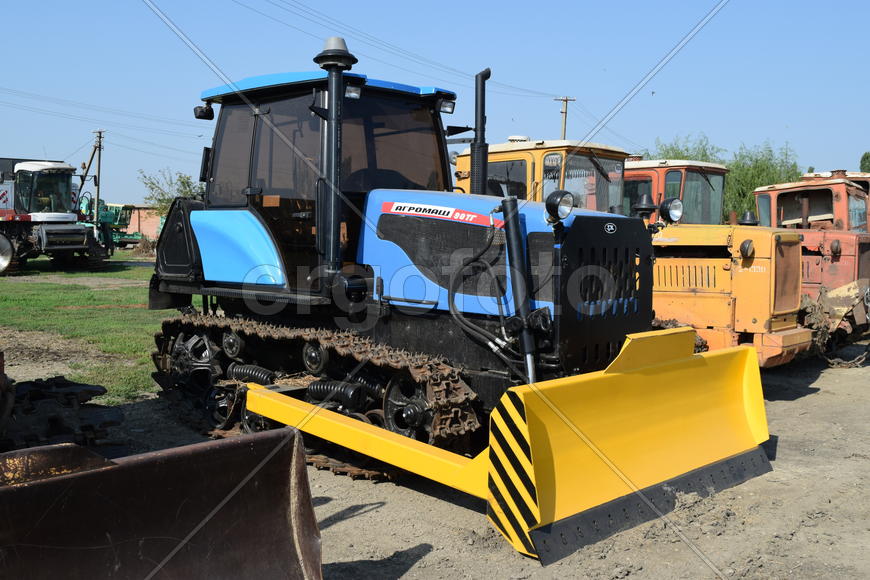 Tractor, standing in a row. Agricultural machinery. Parking of agricultural machinery.