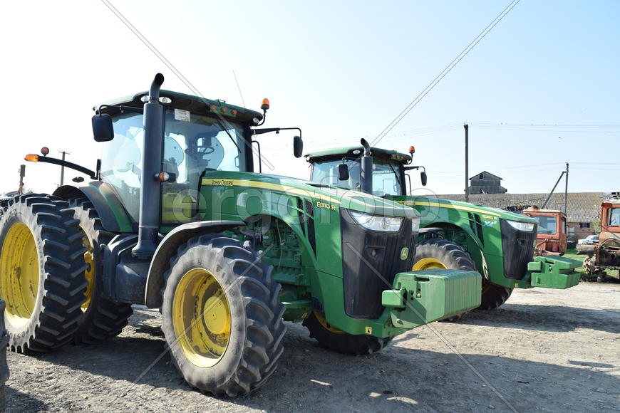 Tractor, standing in a row. Agricultural machinery. Parking of agricultural machinery.
