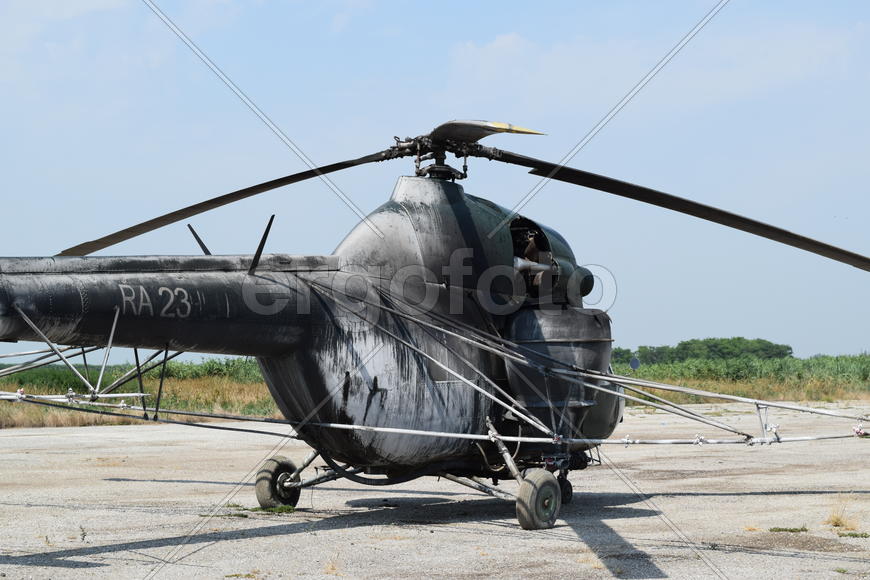 Old helicopter spraying fields. Helicopter spraying fertilizer.