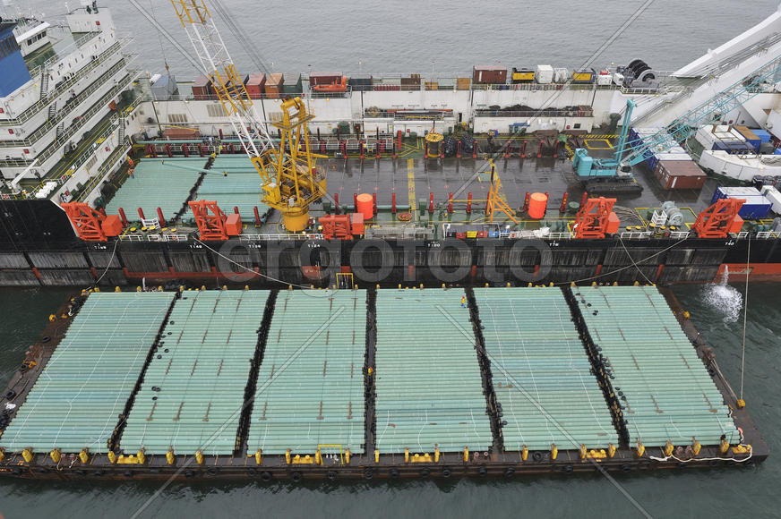 The cargo ship with the crane, the top view. Pipelaying barge