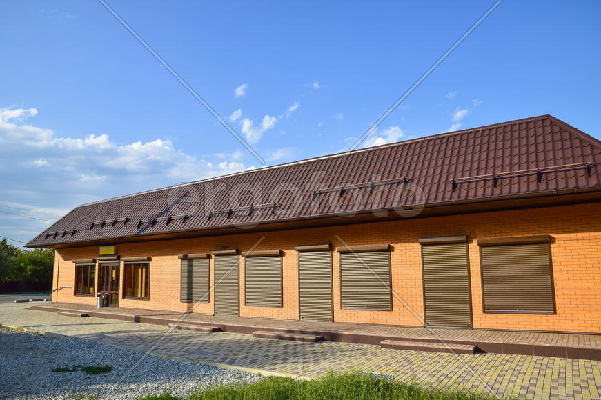 The roof of corrugated sheet on a building. Brown roofing metal sheets on Rented store. 