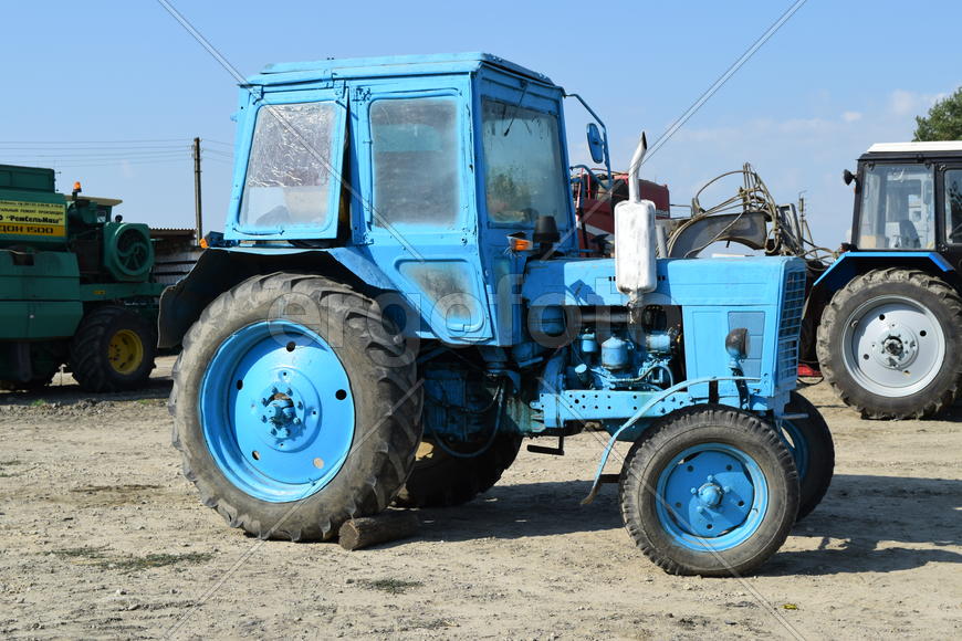 Tractor, standing in a row. Agricultural machinery. Parking of agricultural machinery.